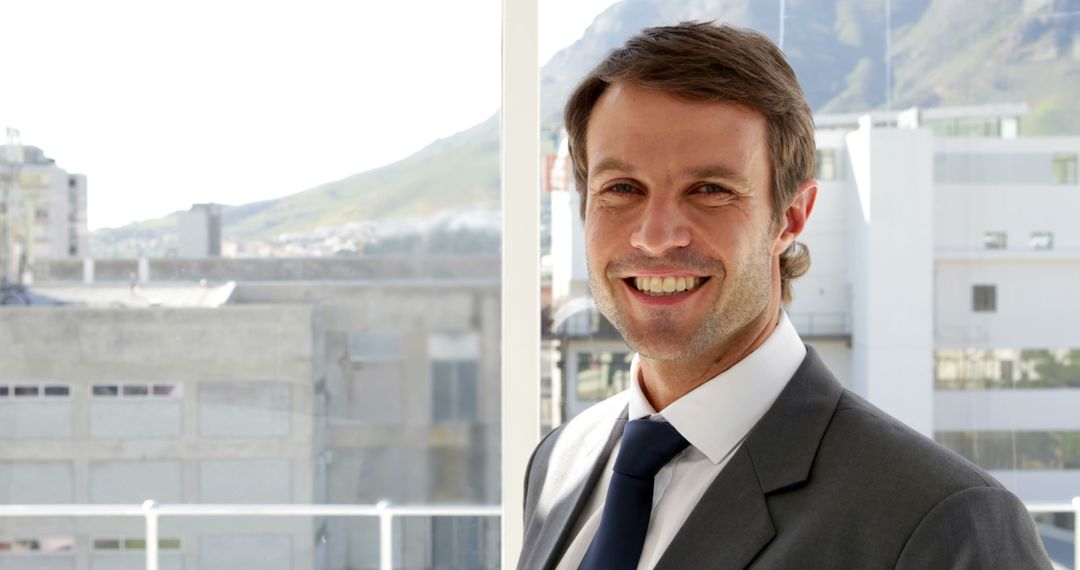 Smiling Businessman in Suit with City View Background - Free Images, Stock Photos and Pictures on Pikwizard.com