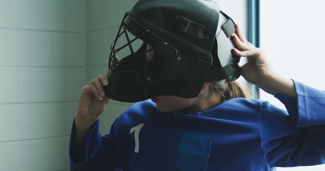 Female Hockey Player Preparing Helmet in Locker Room - Free Images, Stock Photos and Pictures on Pikwizard.com