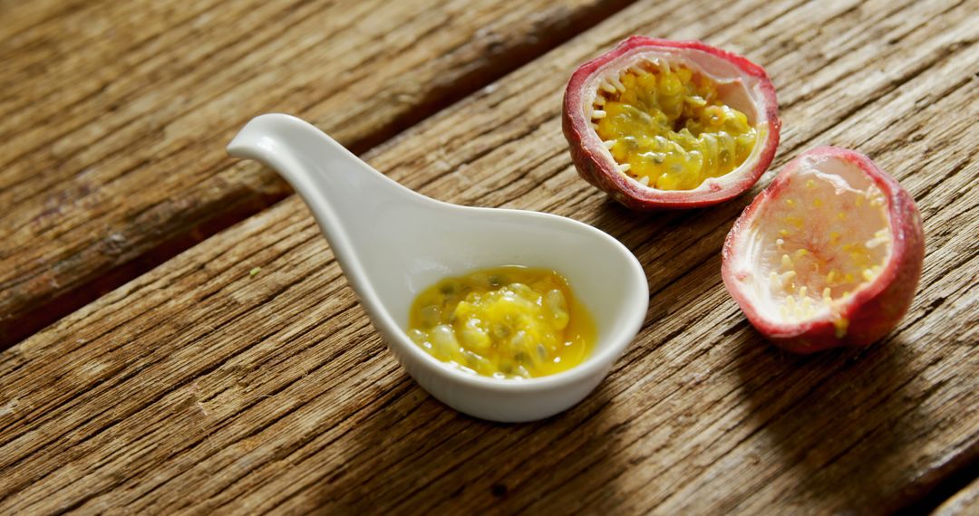 Fresh Passion Fruit Pulp in White Ceramic Spoon on Wooden Table - Free Images, Stock Photos and Pictures on Pikwizard.com