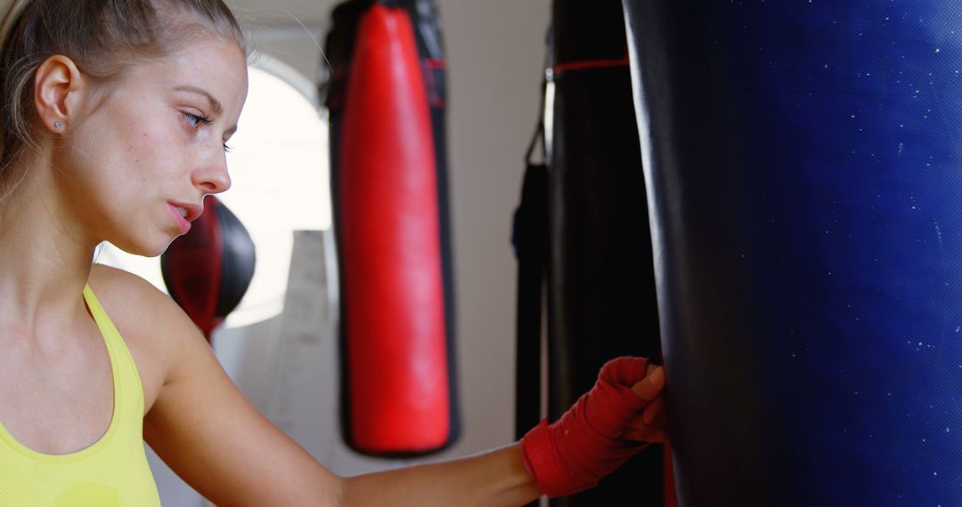 Focused Woman Training with Punching Bag in Gym - Free Images, Stock Photos and Pictures on Pikwizard.com