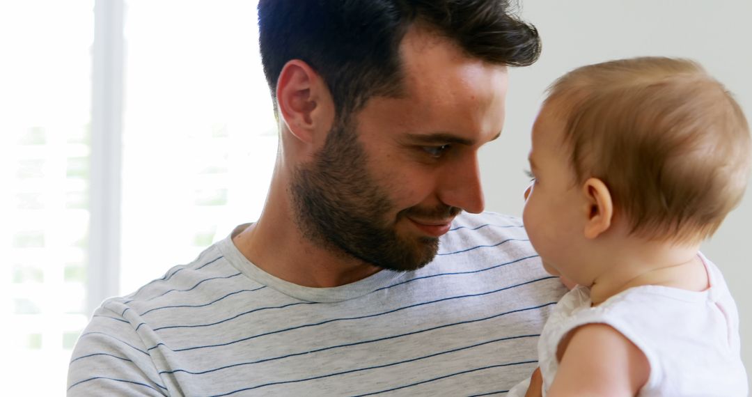 Father and Baby Connecting in Domestic Setting