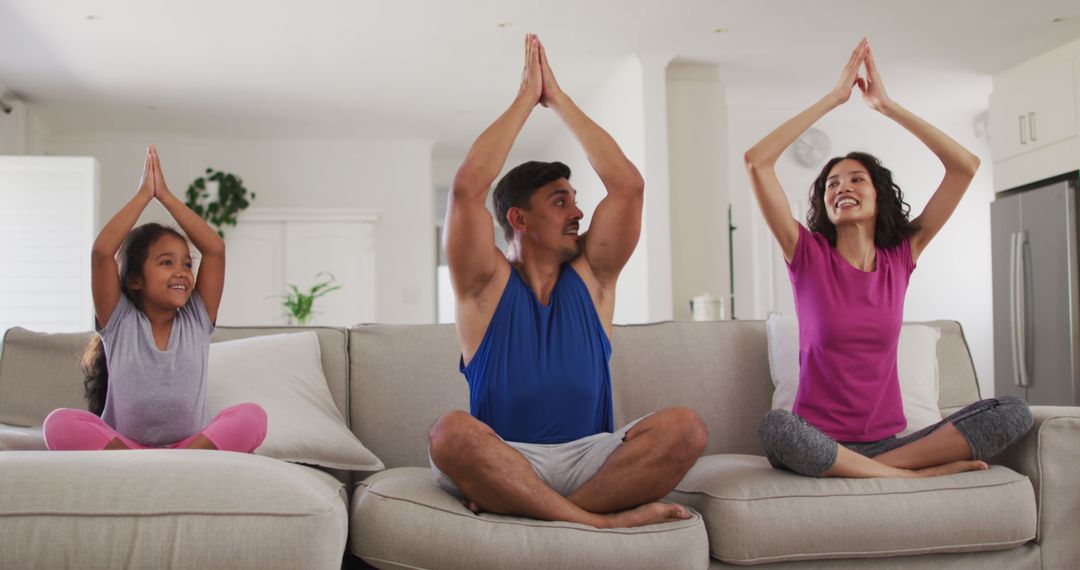 Family Practicing Yoga Together in Living Room on Couch - Free Images, Stock Photos and Pictures on Pikwizard.com