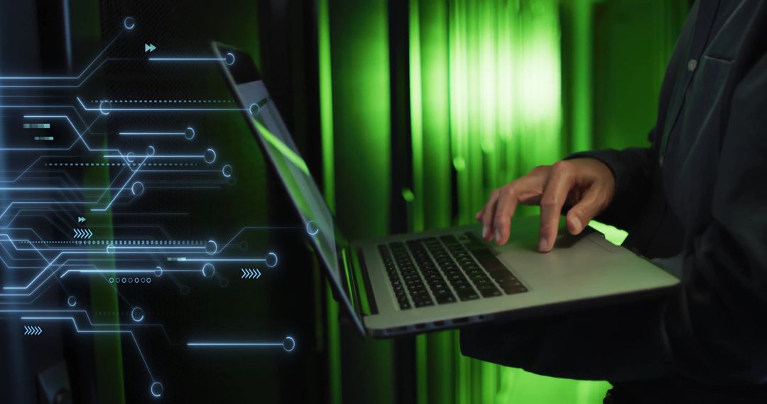 IT Technician Using Laptop with Overlaid Digital Circuitry