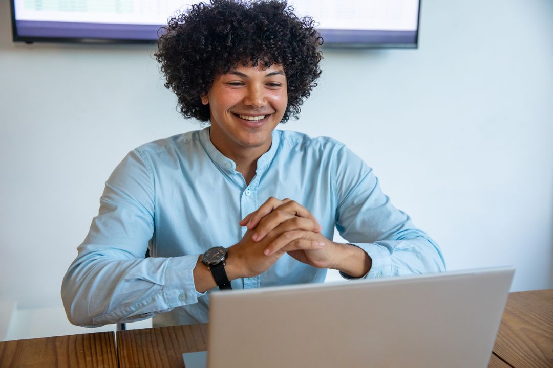 Focused Professional Working on Laptop at Home Desk