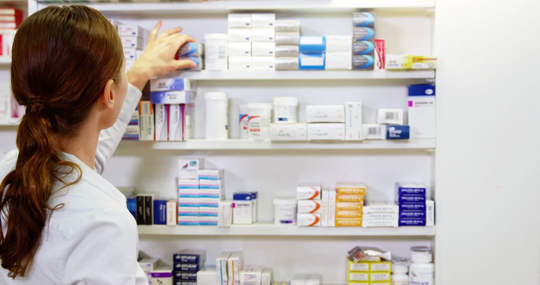 Female Pharmacist Organizing Medication on Shelves - Free Images, Stock Photos and Pictures on Pikwizard.com