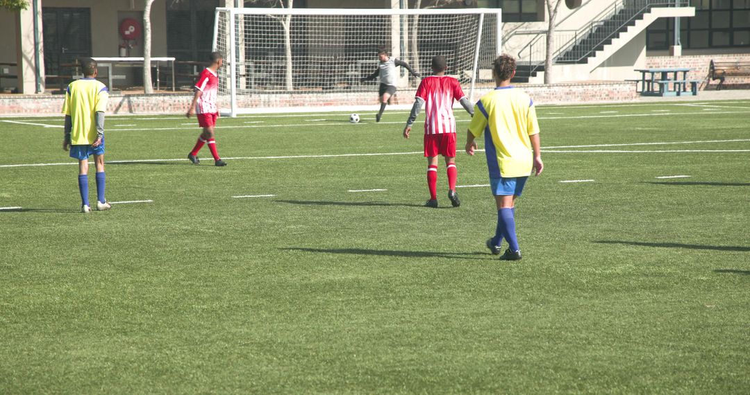 Energetic Soccer Match with Colorful Team Uniforms on Green Field