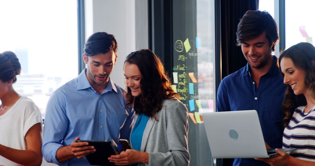 Business Team Collaborating on Technology in Modern Office