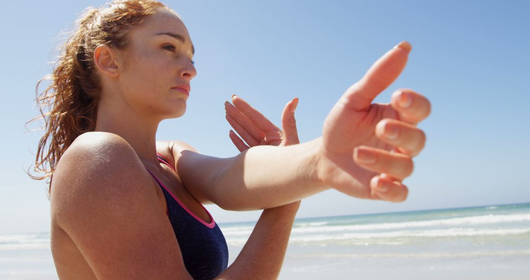 Woman Stretching By Beach in Sportswear - Free Images, Stock Photos and Pictures on Pikwizard.com