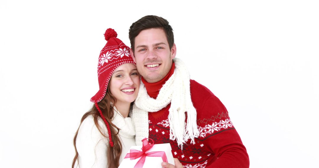 Couple Dressed in Winter Clothing Holding Holiday Gift - Free Images, Stock Photos and Pictures on Pikwizard.com