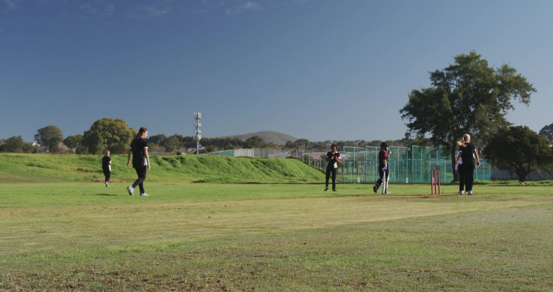 Women Enjoying Cricket Game on Vibrant Green Field