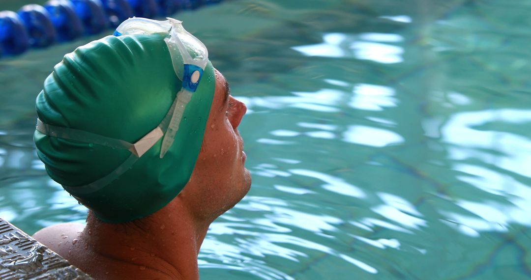 Confident Swimmer Relaxing at Indoor Poolside