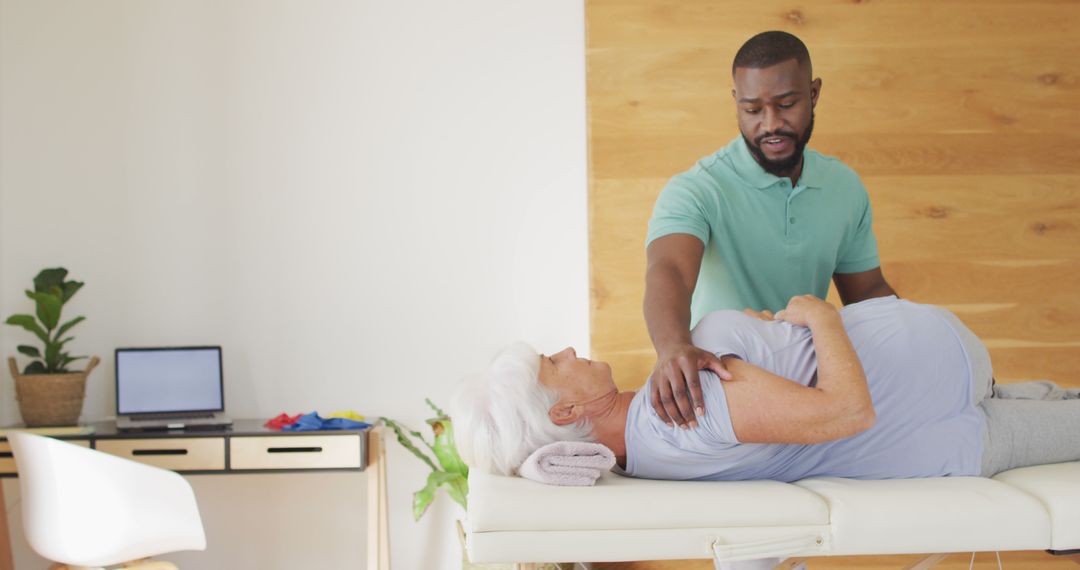 Image of african american male physiotherapist exercising with caucasian senior woman - Free Images, Stock Photos and Pictures on Pikwizard.com