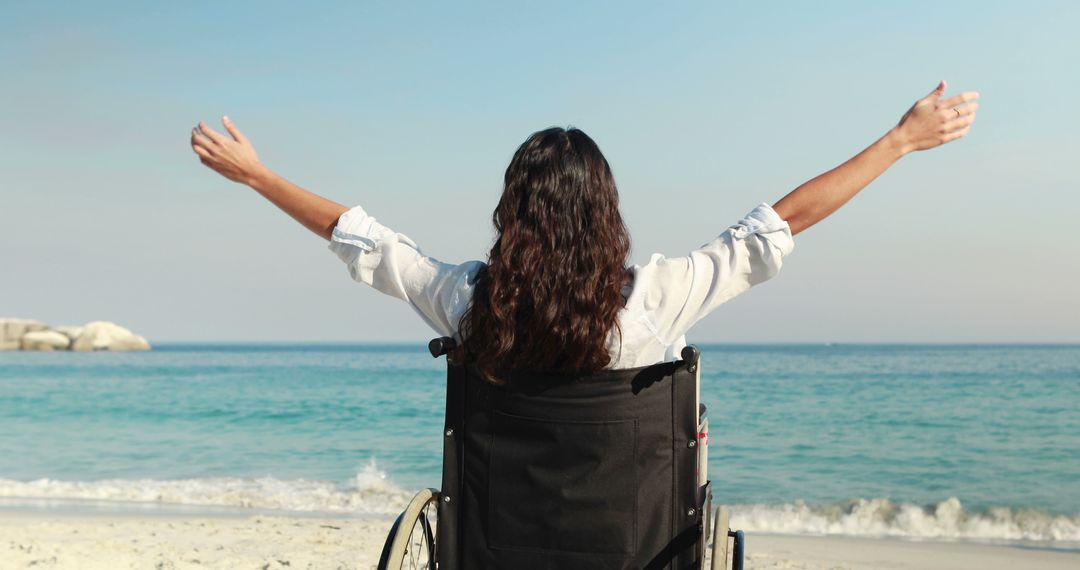 Woman on Wheelchair Enjoying Beach with Open Arms - Free Images, Stock Photos and Pictures on Pikwizard.com