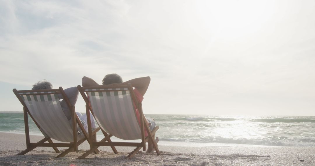 Senior Couple Enjoying Beachfront Relaxation at Sunset