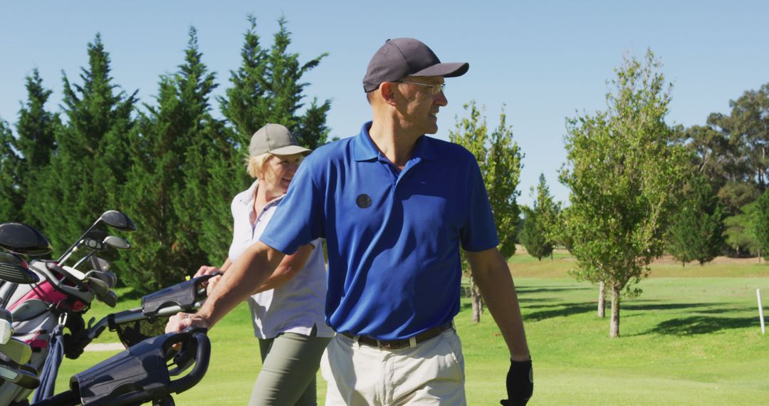 Couple Enjoying a Game of Golf on a Sunny Day - Free Images, Stock Photos and Pictures on Pikwizard.com