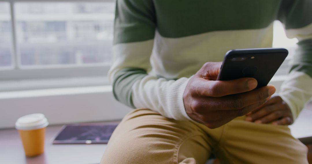 Close Up of Businessman Using Smartphone in Modern Office Setting