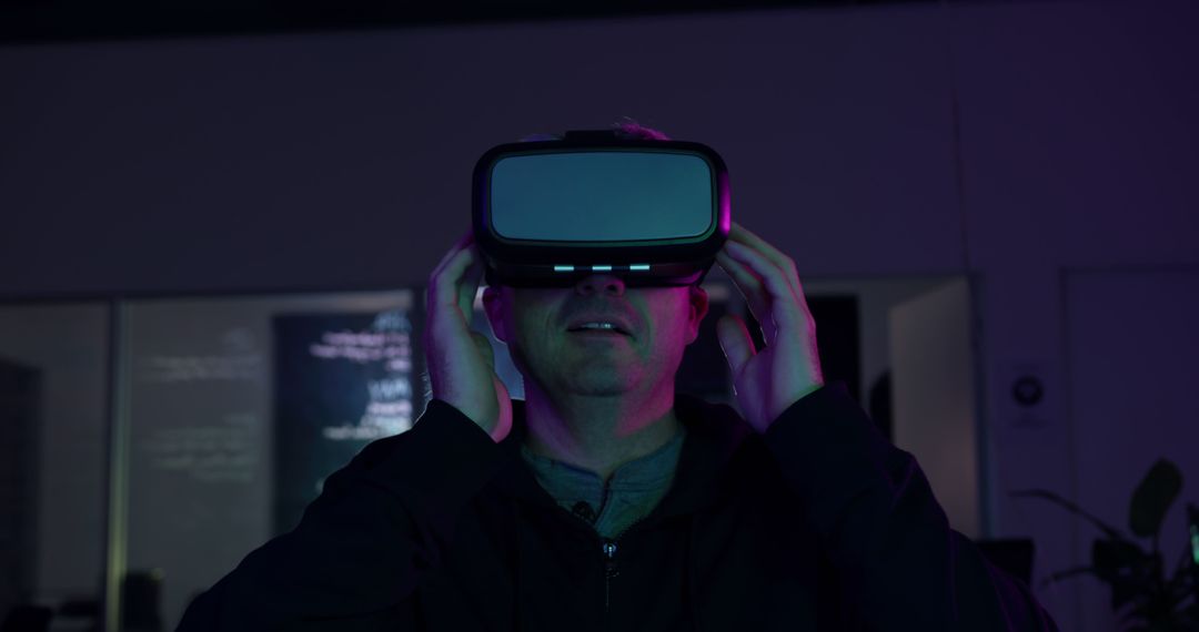 Person Experiencing Virtual Reality with VR Headset in Dimly Lit Room - Free Images, Stock Photos and Pictures on Pikwizard.com