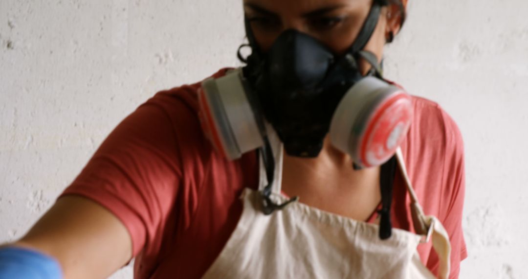 Focused Artisan Wearing Respirator and Apron Working on Project - Free Images, Stock Photos and Pictures on Pikwizard.com