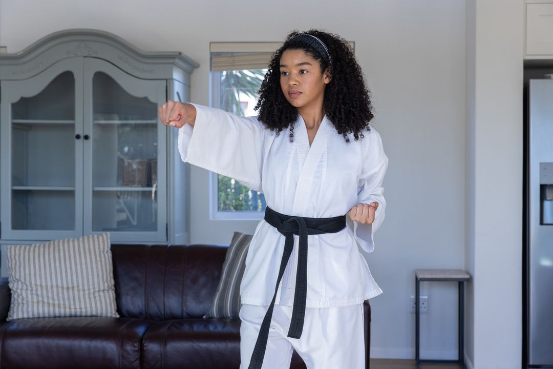 Focused Black Belt Karate Practitioner Training at Home