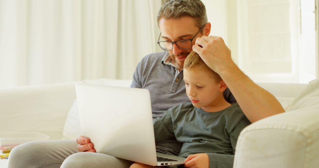 Father Helping Young Son with Laptop on Bright Sunny Day - Free Images, Stock Photos and Pictures on Pikwizard.com