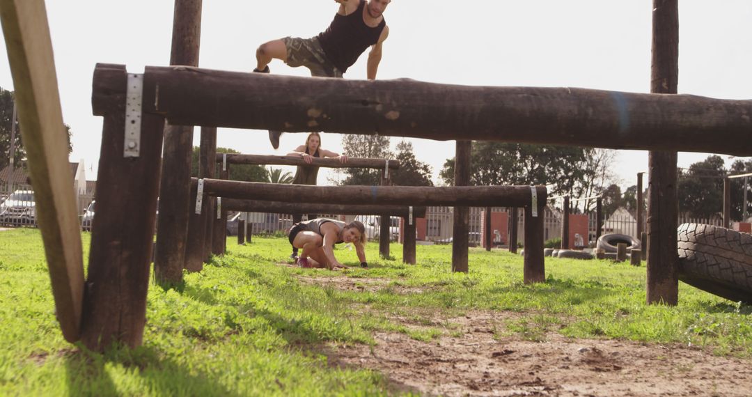 Diverse Individuals Conquering Outdoor Obstacle Course Training