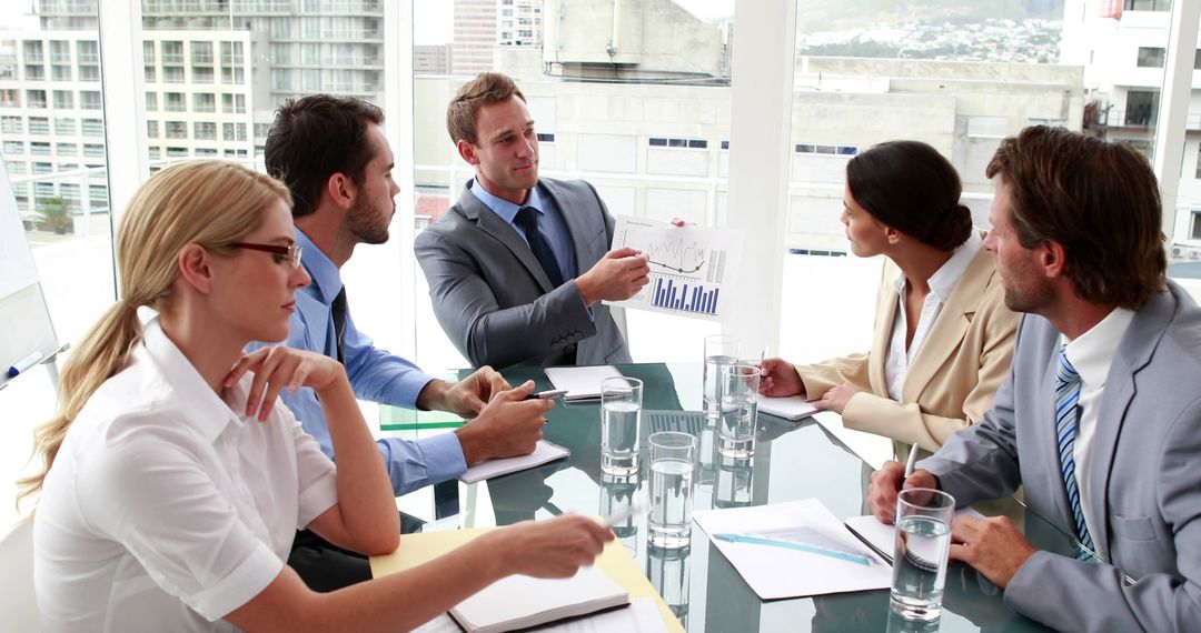 Business team engaged in a financial presentation in a modern office - Free Images, Stock Photos and Pictures on Pikwizard.com