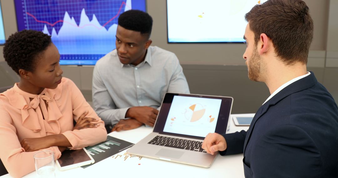 Diverse Team Analyzing Business Data During Corporate Meeting