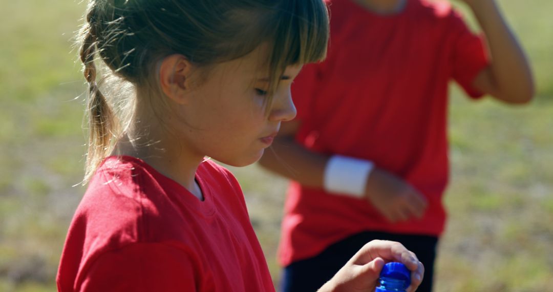 Young Girl Drinking Water During Outdoor Sports Activity - Free Images, Stock Photos and Pictures on Pikwizard.com