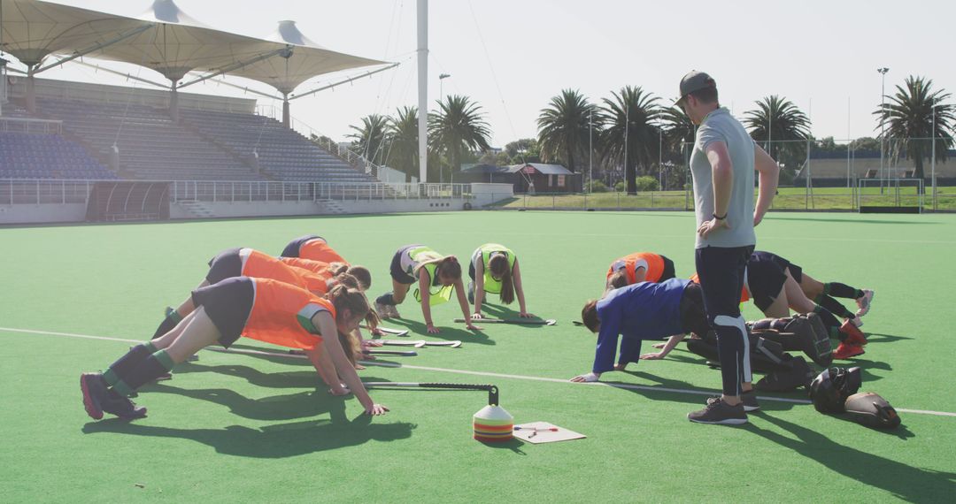 Field Hockey Team Practicing Push-ups During Training Session - Free Images, Stock Photos and Pictures on Pikwizard.com