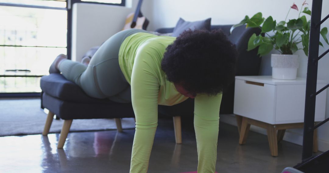 Woman practicing plank exercise in cozy apartment living room - Free Images, Stock Photos and Pictures on Pikwizard.com