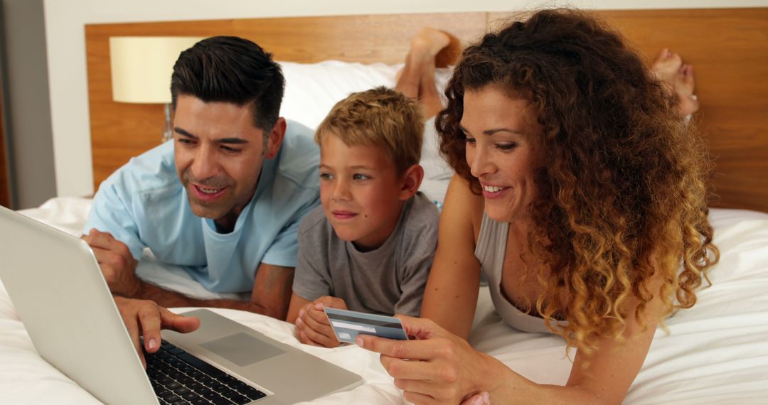 Family Online Shopping on Bed with Laptop and Credit Card - Free Images, Stock Photos and Pictures on Pikwizard.com