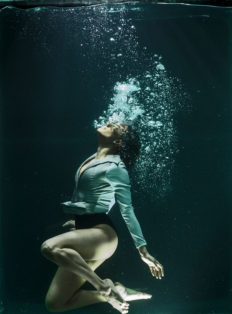 Woman in formal attire underwater with breathing bubbles - Free Images, Stock Photos and Pictures on Pikwizard.com