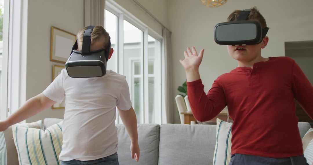 Caucasian boy with brother using vr headsets and standing in living room - Free Images, Stock Photos and Pictures on Pikwizard.com
