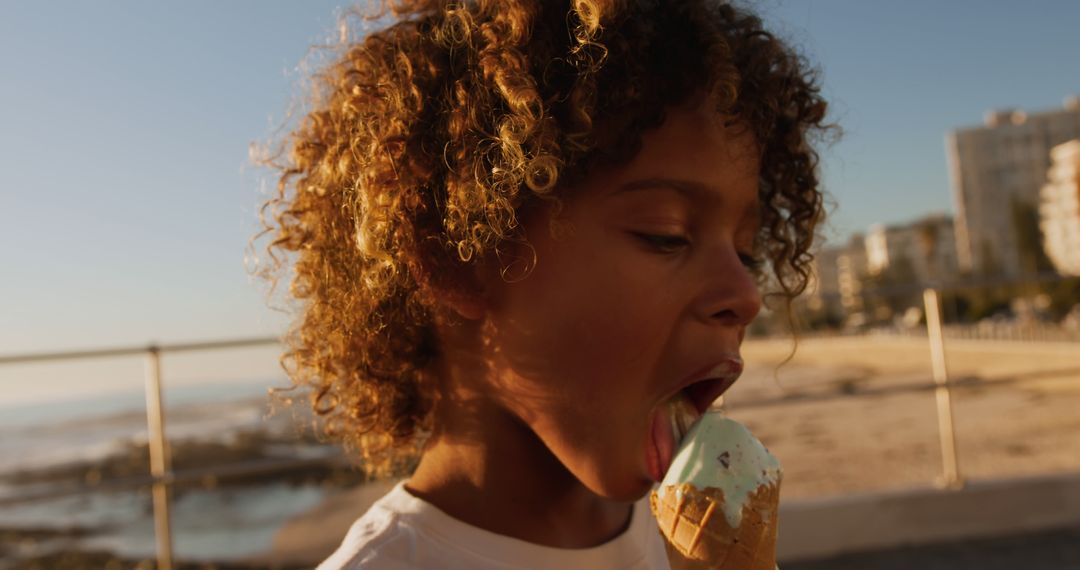 Child Enjoying Ice Cream at Sunset by the Beach - Free Images, Stock Photos and Pictures on Pikwizard.com