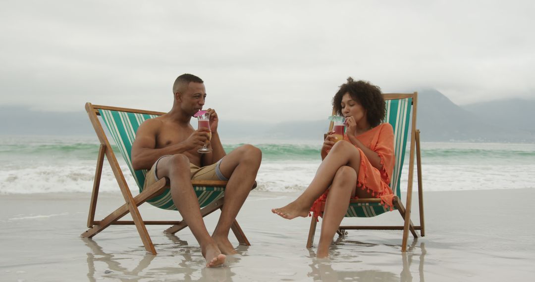 Couple Relaxing on Beach with Drinks in Tropical Paradise - Free Images, Stock Photos and Pictures on Pikwizard.com