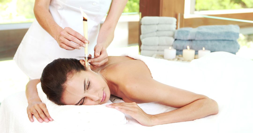 Woman Receiving Ear Candling Therapy at a Relaxing Spa - Free Images, Stock Photos and Pictures on Pikwizard.com