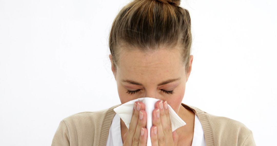 Woman Blowing Nose into Tissue Paper with Eyes Closed - Free Images, Stock Photos and Pictures on Pikwizard.com