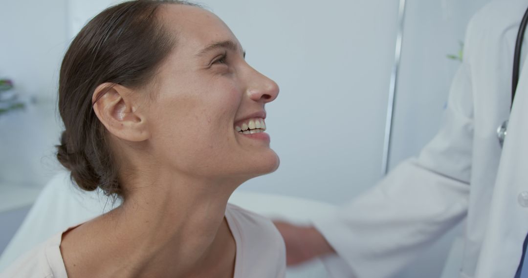 Female Patient Smiling During Medical Checkup - Free Images, Stock Photos and Pictures on Pikwizard.com