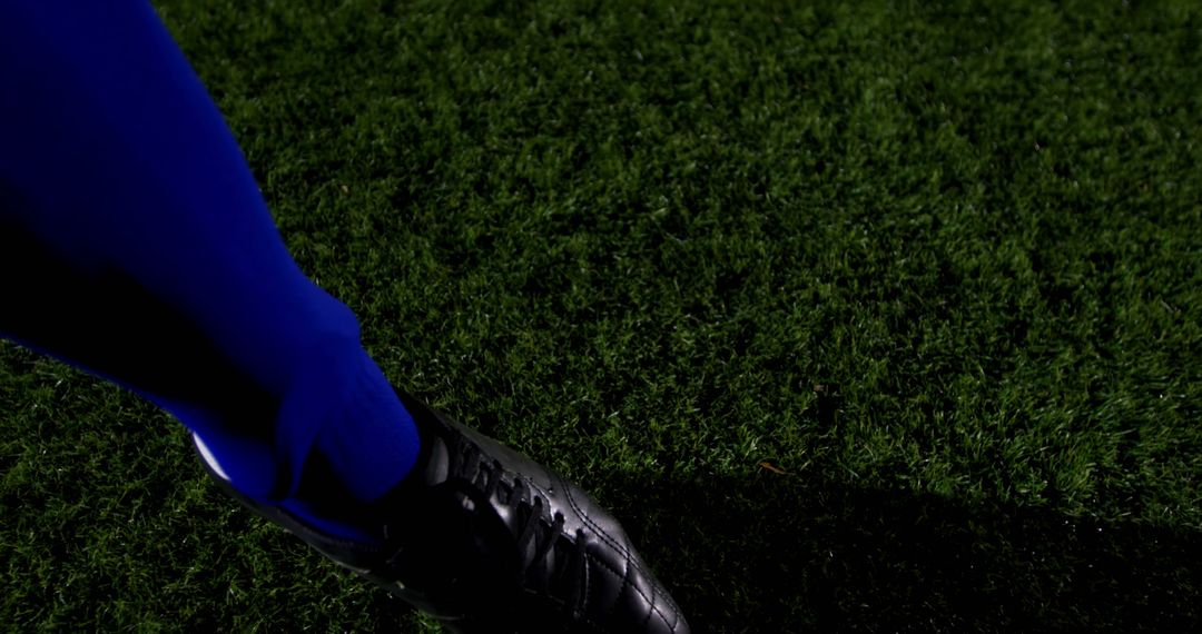 Close-Up of Soccer Player's Foot on Grass Field at Night - Free Images, Stock Photos and Pictures on Pikwizard.com