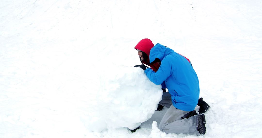 Child Building Snow Fort on Snowy Winter Day - Free Images, Stock Photos and Pictures on Pikwizard.com