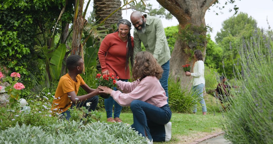 Diverse Family Enjoys Gardening in Lush Backyard