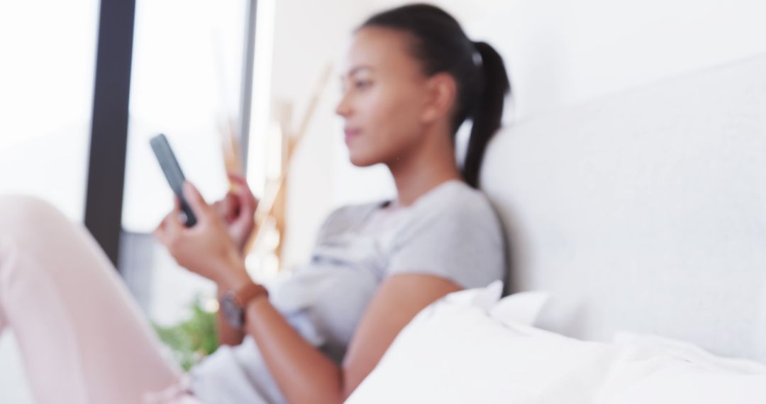 Young Woman Relaxing on Couch with Smartphone - Free Images, Stock Photos and Pictures on Pikwizard.com