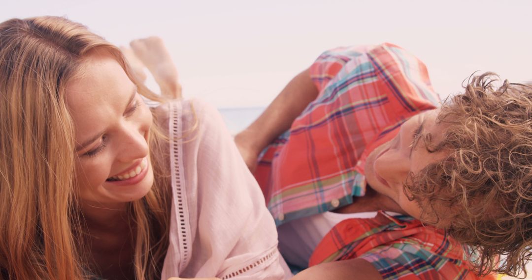 Young Couple Enjoying Relaxed Beach Time with Joyful Connection