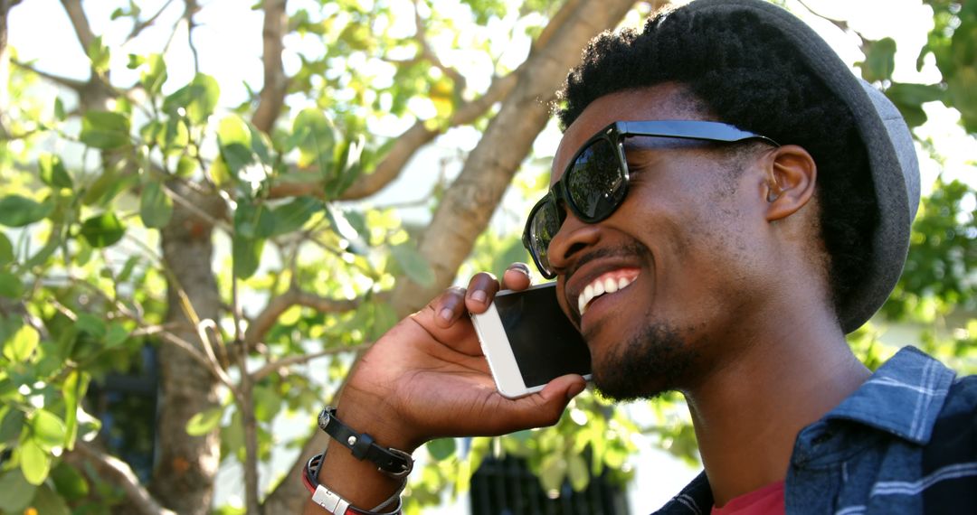 Happy African American Man Talking on Smartphone Outdoors - Free Images, Stock Photos and Pictures on Pikwizard.com