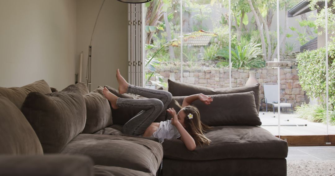 Child Relaxing on Sofa Inside Modern Home - Free Images, Stock Photos and Pictures on Pikwizard.com