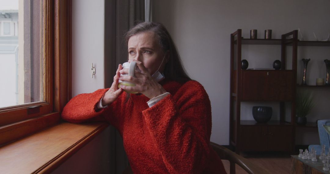 Middle-Aged Woman Drinking Coffee by Window in Cozy Home - Free Images, Stock Photos and Pictures on Pikwizard.com