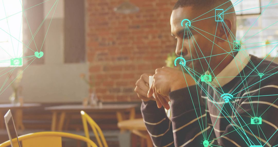 Working in cafe drinking coffee while focusing on laptop with digital network overlay