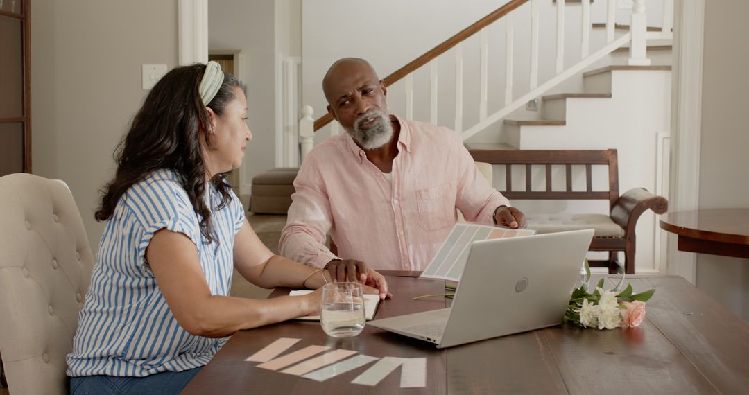 Senior Couple Exploring Home Design with Color Swatches