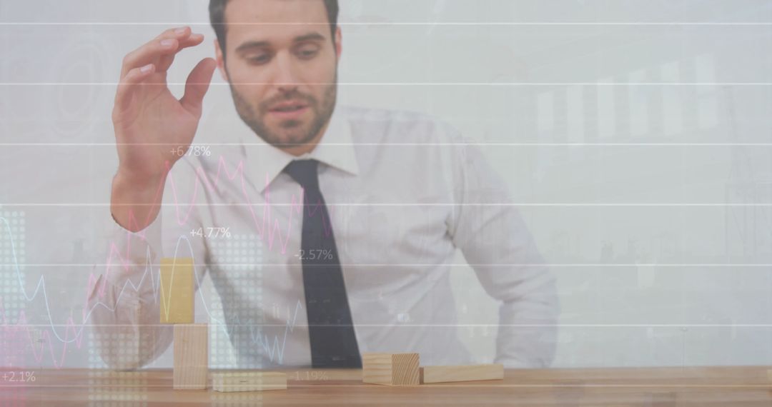 Businessman Strategizing with Double Exposure of Financial Graph Overlays