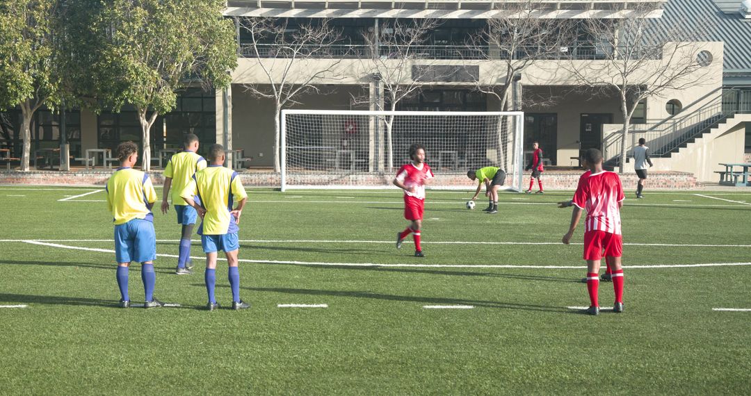 Soccer Players on School Field Practicing Penalty Kick